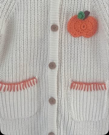 Cream baby cardigan with crochet pumpkin